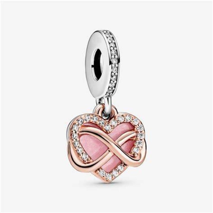 A gold and pink charm necklace from the Barbie x Kendra Scott collection