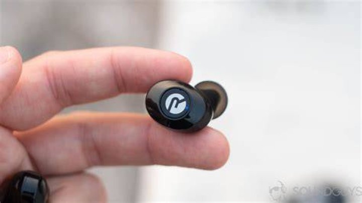 Raycon E25 earbuds 7 of 8 A man holds the Raycon E25 case open which reveals the true wireless earbuds.