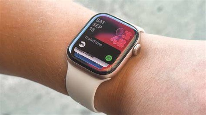 An Apple Watch Series 7 on a user's wrist displays an image of the Chrysler building in their Photo watch face.