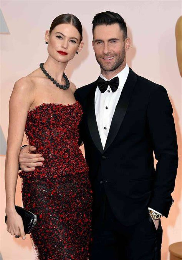 Behati Prinsloo and Adam Levine outside