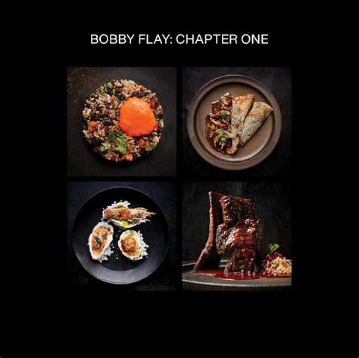 Bobby Flay smiles in a white chef coat