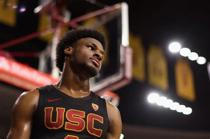 Bronny James in his USC jersey alongside LeBron James looking hyped