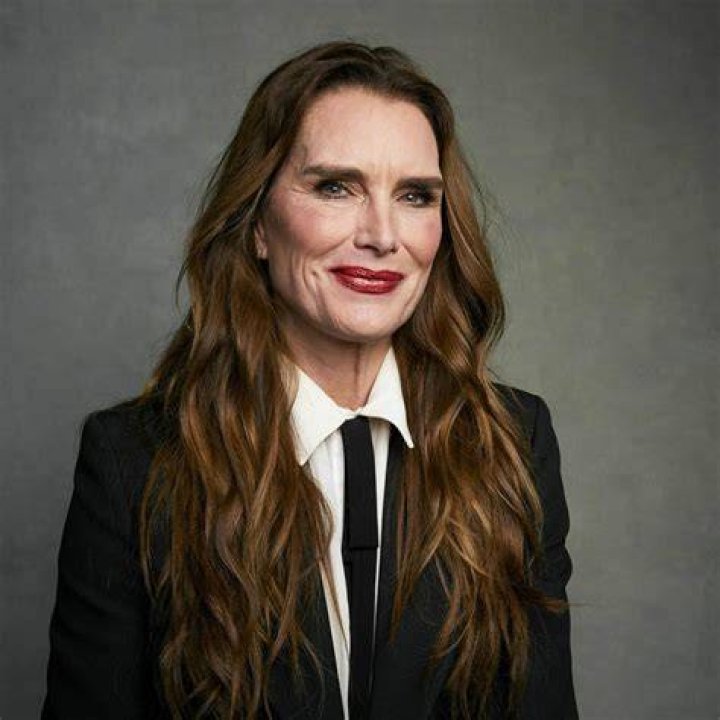 Brooke Shields wearing a polka dot top, and red lipstick.