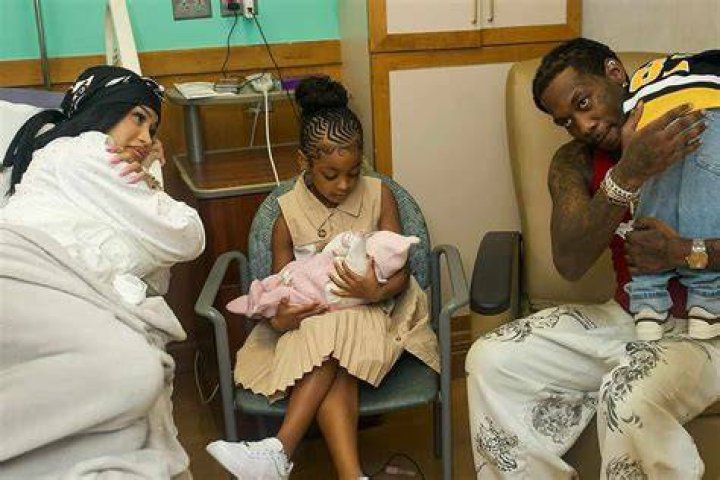 Cardi B and Offset holding hands and walking