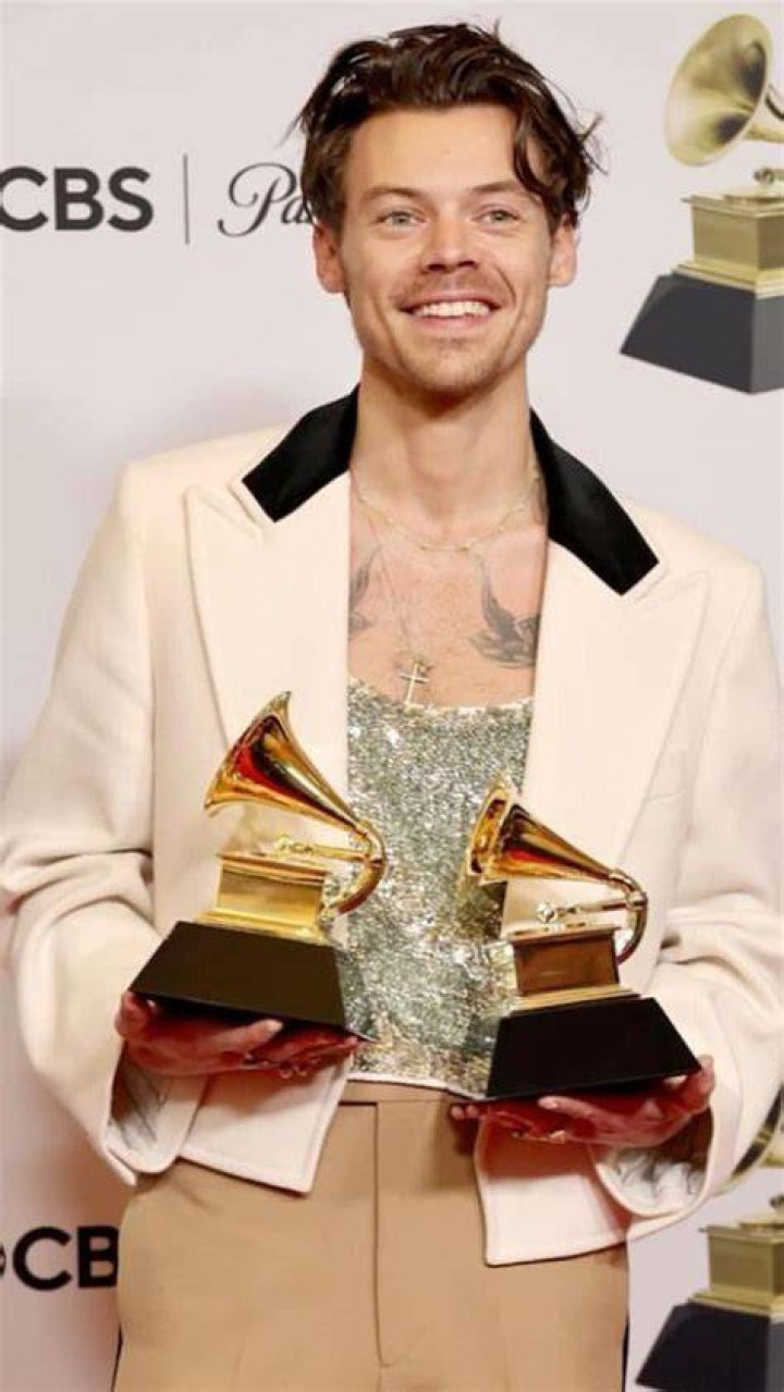 Harry Styles holding Grammys