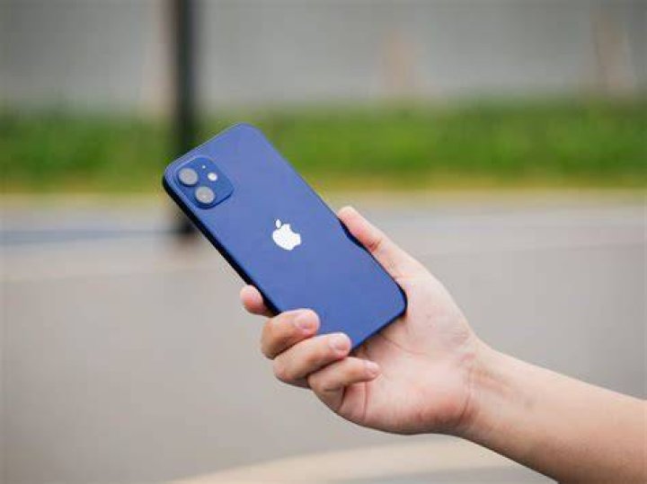 iPhone 12 in hand back 1 iPhone 12 in hand back 1