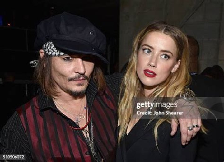 Johnny Depp and actress Amber Heard arrive at the Los Angeles premiere of '3 Days to Kill' at ArcLight Cinemas on February 12, 2014 in Hollywood, California.