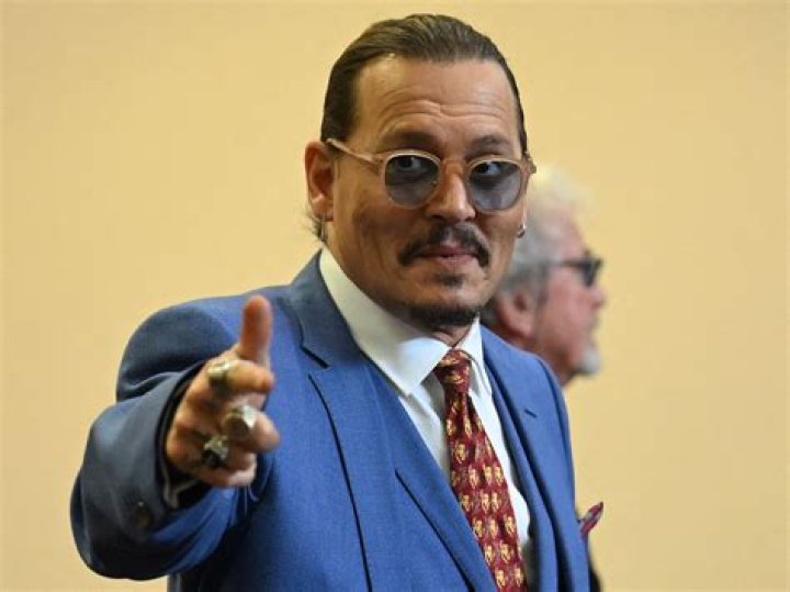 Johnny Depp gestures while departing the courtroom at the Fairfax County Circuit Courthouse in Fairfax, Virginia, on May 24, 2022. - Depp is suing ex-wife Amber Heard for libel after she wrote an op-ed piece in The Washington Post in 2018 referring to herself as a public figure representing domestic abuse.