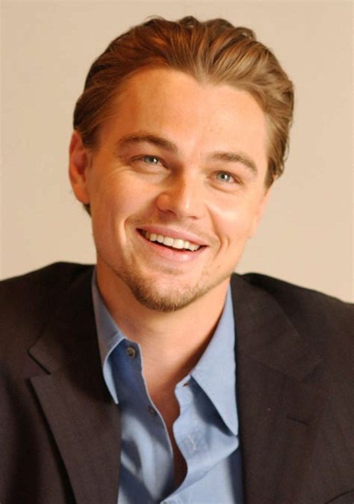 Leonardo DiCaprio smiling at an event.