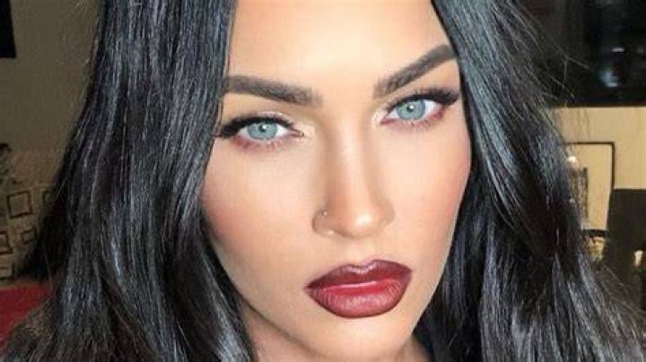 Megan Fox taking a selfie in a red dress