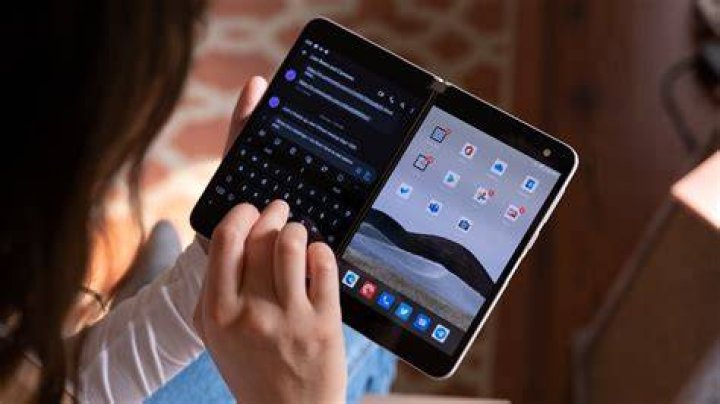 Microsoft Surface Duo using opened and typing Microsoft Surface Duo using opened and typing
