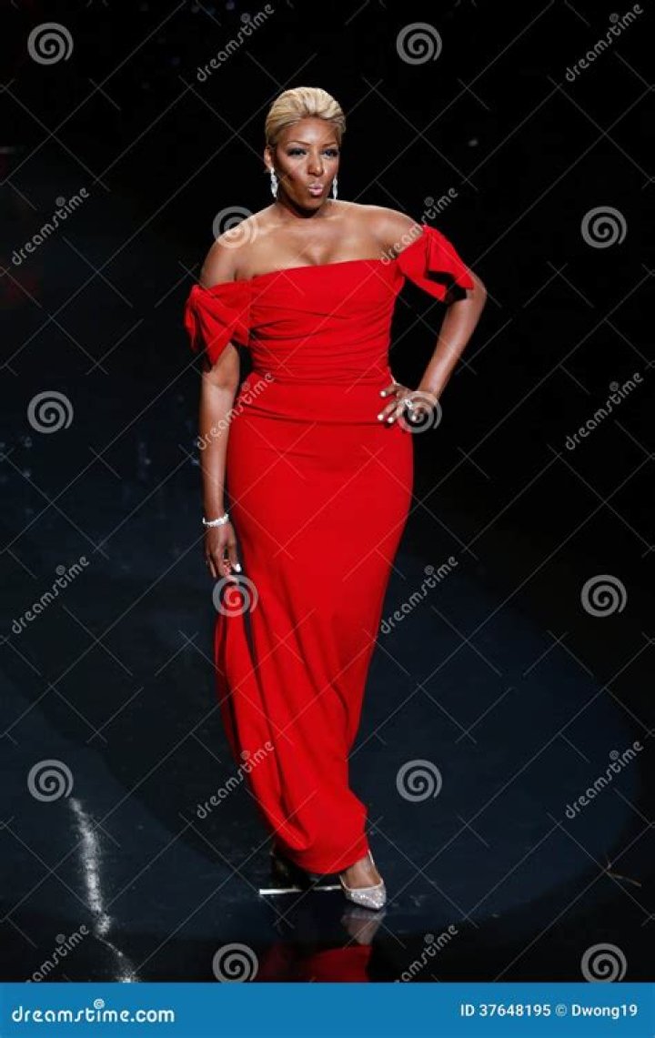 Nene Leakes wearing a black gown with her hands on her waist