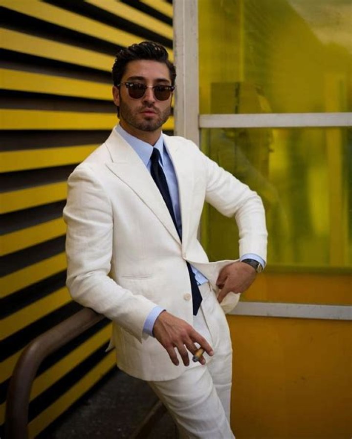 RuPaul in white suit and shirt