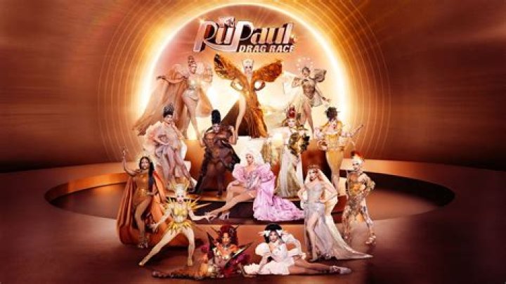 RuPaul laughing in red and pink outfit