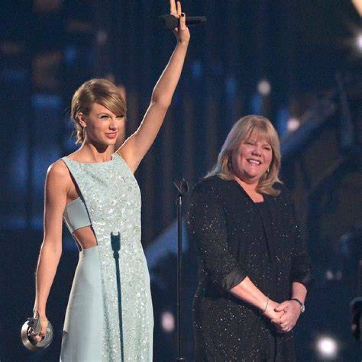 Taylor Swift with her mom, Travis Kelce with his mom