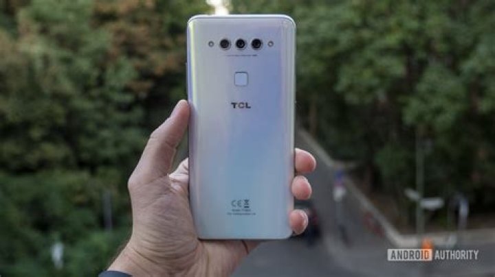 TCL Plex hands on white in hand phone call up to ear TCL Plex hands on white in hand phone call up to ear