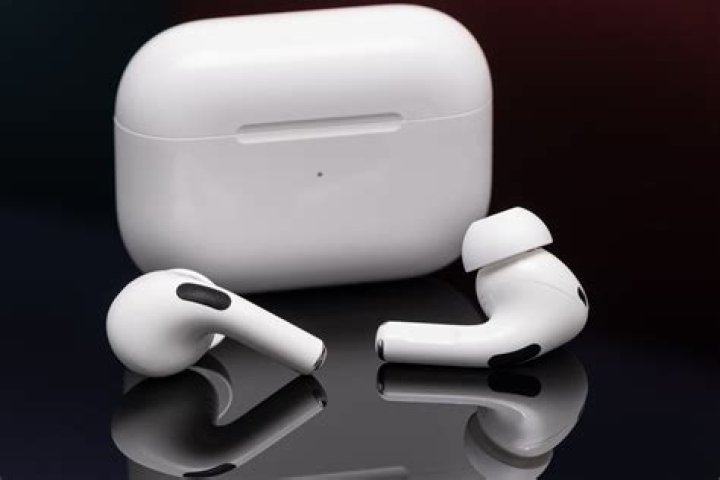 Apple-Airpods5 The first-generation Apple AirPods in the case on a black background.
