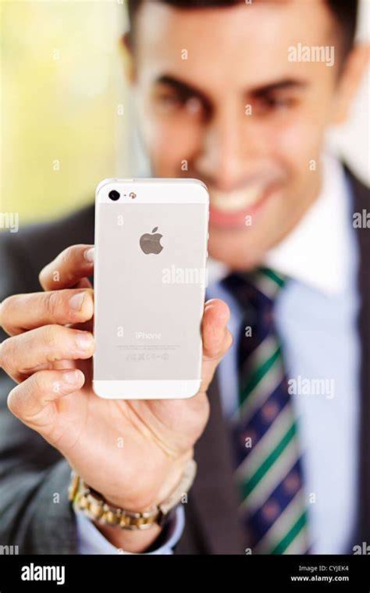 Streaming-services-2-1200x675 Tidal Man holding iPhone with folder open containing various music streaming apps.