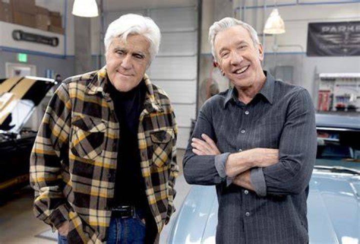 tim allen and jay leno posing in front of a car