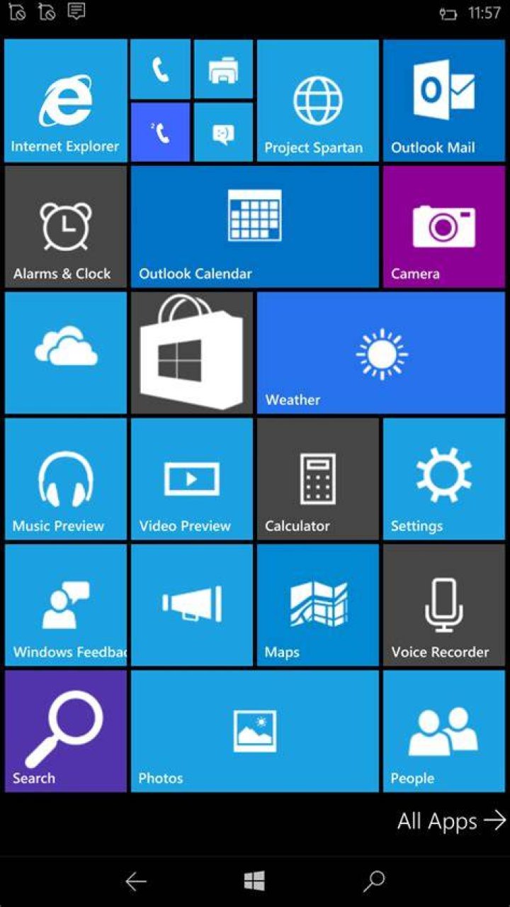 Windows 10 Mobile start screen Windows 10 Mobile start screen on phone in hand