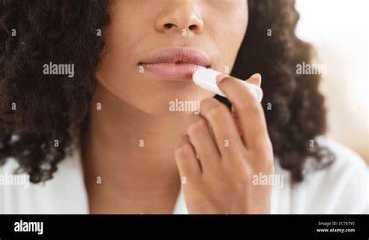 Woman applying chapstick