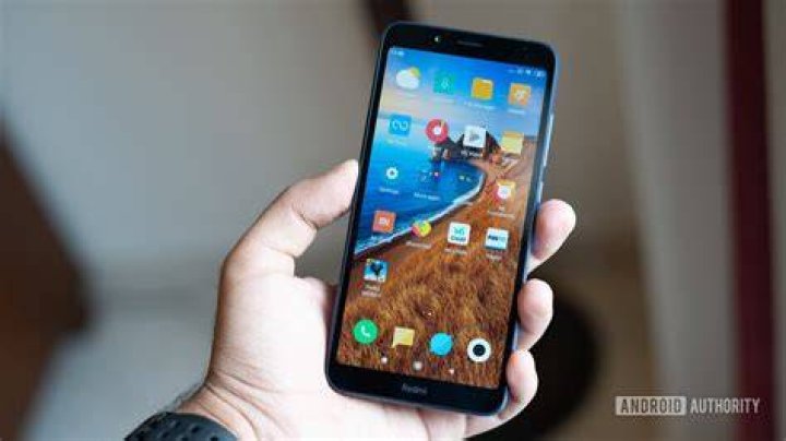 Xiaomi Redmi 7A in hand showing display Xiaomi Redmi 7A in hand showing display